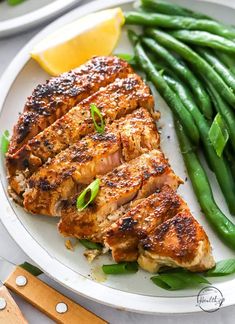 grilled chicken and green beans on a white plate