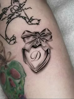 a black and white photo of a tattoo with a bow on it