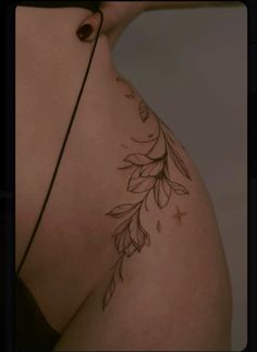 the back of a woman's breast with leaves on it