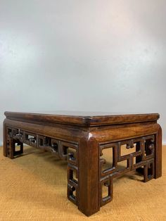 a wooden bench with intricate carvings on the top