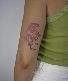 a woman with a dragon tattoo on her arm