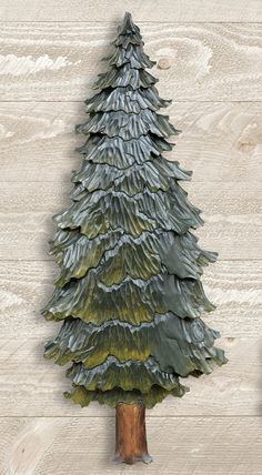 a ceramic christmas tree sitting on top of a wooden table