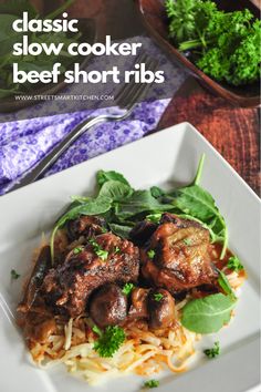 beef short ribs with noodles and spinach in a white bowl on a wooden table