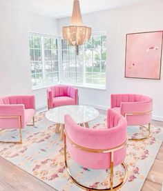 a living room filled with furniture and a chandelier