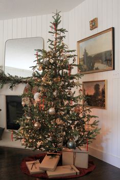 a small christmas tree with presents under it