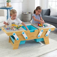 two children playing with toys in a living room