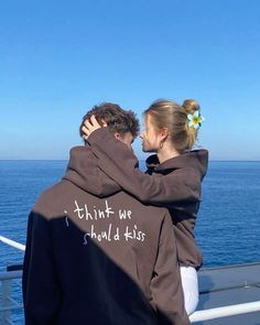 a man and woman embracing on the deck of a ship