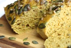 a loaf of pumpkin seed bread on a cutting board