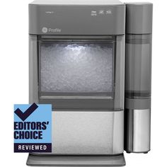 a silver refrigerator freezer sitting on top of a white counter next to a blue sticker that says editor's choice