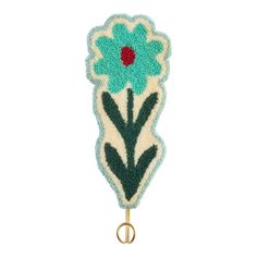 a blue and green flower on a hook