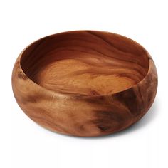 a wooden bowl sitting on top of a white surface