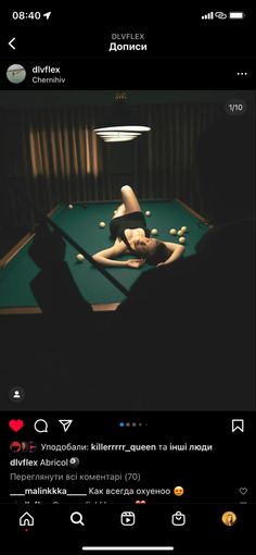 a woman laying on top of a pool table