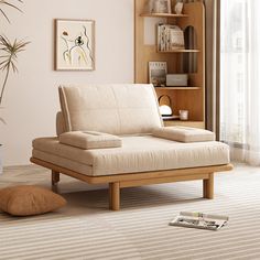 a living room scene with focus on the chaise lounger and bookshelf