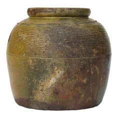 an old, dirty vase is shown against a white background