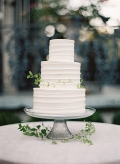 a white wedding cake sitting on top of a table