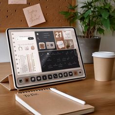 an open laptop computer sitting on top of a wooden desk next to a cup of coffee