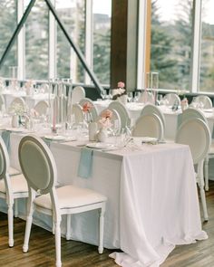 the tables are set with white linens and pink flowers