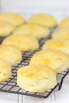 biscuits cooling on a wire rack with the words light and fluffy angel biscuits