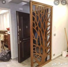 an open wooden door in the middle of a room with other items on the floor