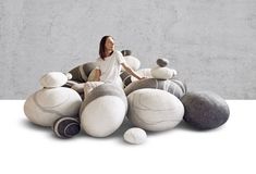 a woman sitting on top of a pile of stuffed animals