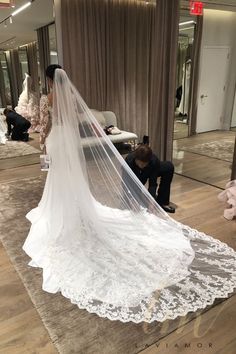 the bride is getting ready to walk down the aisle in her wedding dress and veil