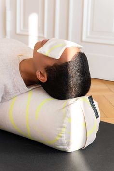 a man laying on top of an inflatable pillow with a bandage around his head