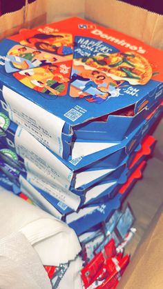 a stack of children's books sitting on top of each other in a cardboard box