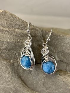 These elegant blue apatite drop earrings are striking . The micro faceted surface of these genuine apatite gemstones is beautiful and really catches the eye. They are a gorgeous ocean blue color. I chose to enhance these earrings with a Celtic inspired silver wire design to let the natural beauty of the stone shine. Featuring an 8mm genuine blue apatite gemstone. These earrings are dainty, lightweight and perfect for everyday wear. Pair these flattering earrings with your favorite outfit, dresse Blue Apatite Gemstone Earrings, Handmade Blue Apatite Earrings, Blue Apatite Earrings For Gift, Blue Apatite Earrings Gift, Blue Earrings For Gift, Flattering Earrings, Ocean Blue Color, Apatite Jewelry, Wire Design