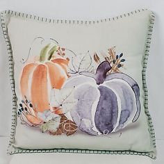 a decorative pillow with pumpkins on it