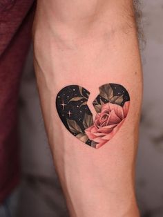 a heart shaped tattoo with a rose on the inside of it and stars in the background