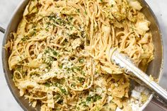 a pan filled with pasta covered in parmesan cheese