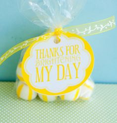 a yellow and white treat bag with a tag that says thanks for brightening my day