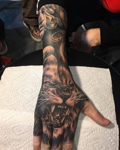 a hand with a tiger tattoo on it