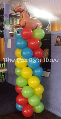 there is a tall balloon tower in the room