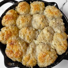 a cast iron skillet filled with biscuits