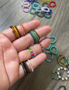 "Summer is coming up, which means cute and colorful jewelry is going to be every outfits best friend! Seed bead rings are super cute and can really go a long way when styling. These are made with elastic and are stretchy, so they will fit everyone even if you are unsure of your ring size.  Each order comes with a set of 5 beaded rings, so make sure you put what color(s) you would like! I offer every color, so if there is a specific color palette or just one color for all, please let me know so t Seed Bead Rings, Bead Rings, Random Colors, Summer Is Coming, Colorful Jewelry, Rings Set, Cat Friendly Home, Beaded Rings, Every Color