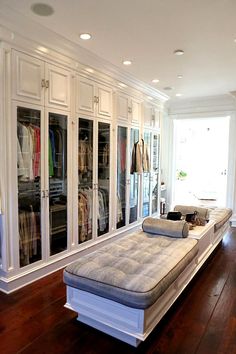 a bed sitting on top of a hard wood floor next to a walk in closet