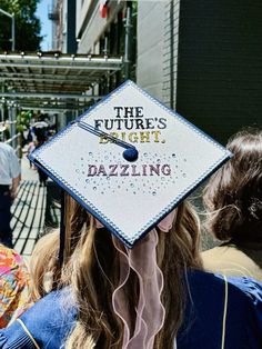 a woman wearing a graduation cap that says the future's right dazzling