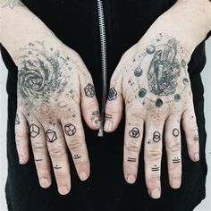 two hands with different tattoos on them