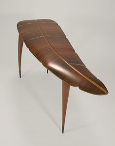 a wooden bench with an unusual design on it