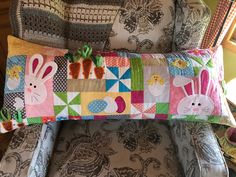 a baby's seat cushion with bunny and carrots on it