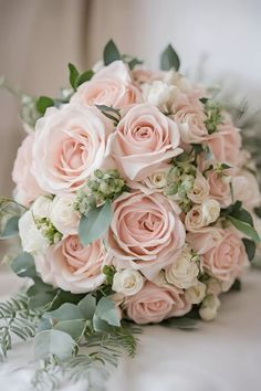 a bridal bouquet with pink roses and greenery