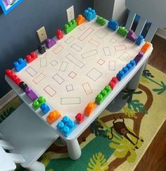 a child's play table with legos on it