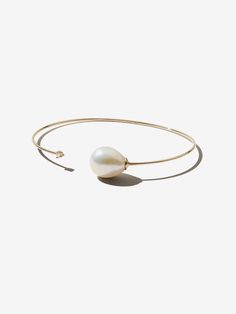 A gold cuff with minimalist simplicity. A large white pearl is beautifully offset by a diamond in this open cuff. Perfect for everyday and easily stacked. Freshwater pearl 14kt gold 0.02 ct International orders : Duties, Taxes and VAT are not included in the total at checkout. Payment of any Duties, Taxes and VAT is th Pearl Bangle, Pearl Leather, Gold Cuffs, Pearl Strands, Beauty Collection, Pearl Chain, Beauty Essentials, 14kt Gold, White Pearl