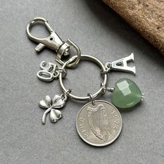 a keychain with a coin and charms attached to it