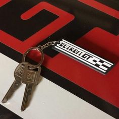 a close up of a keychain with a car tag on it's side