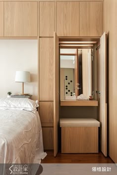 a bedroom with a bed, dresser and mirror in the corner next to a night stand