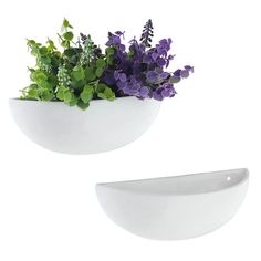 two white bowls filled with purple flowers on top of each other and one has green leaves in it