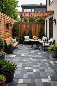 an outdoor patio with seating and potted plants