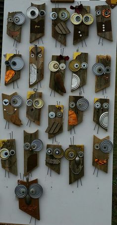 an art display with various items made from wood and metal eyes on the top, one eye has been cut out to look like owls